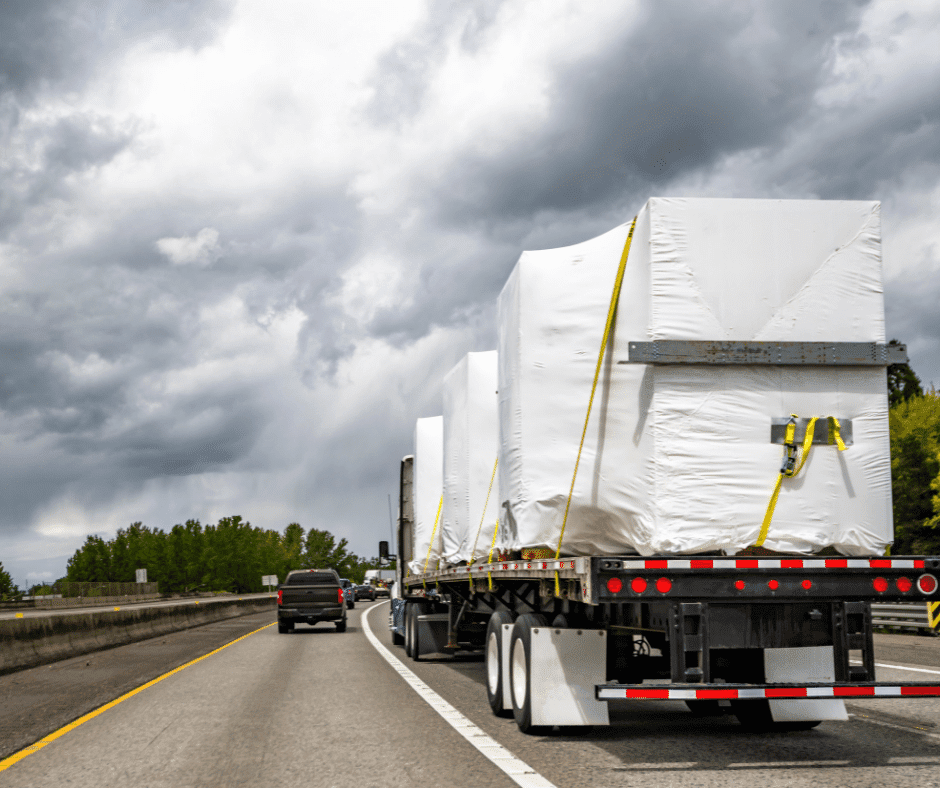 Image of heavy-duty truck carrying a large load on road