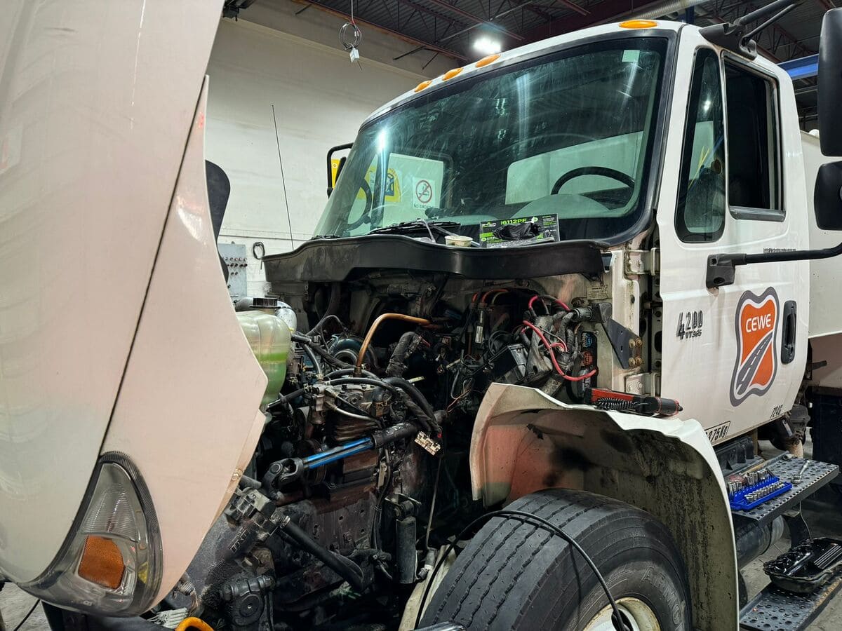 Truck with the hood up for diesel engine inspection in Coquitlam